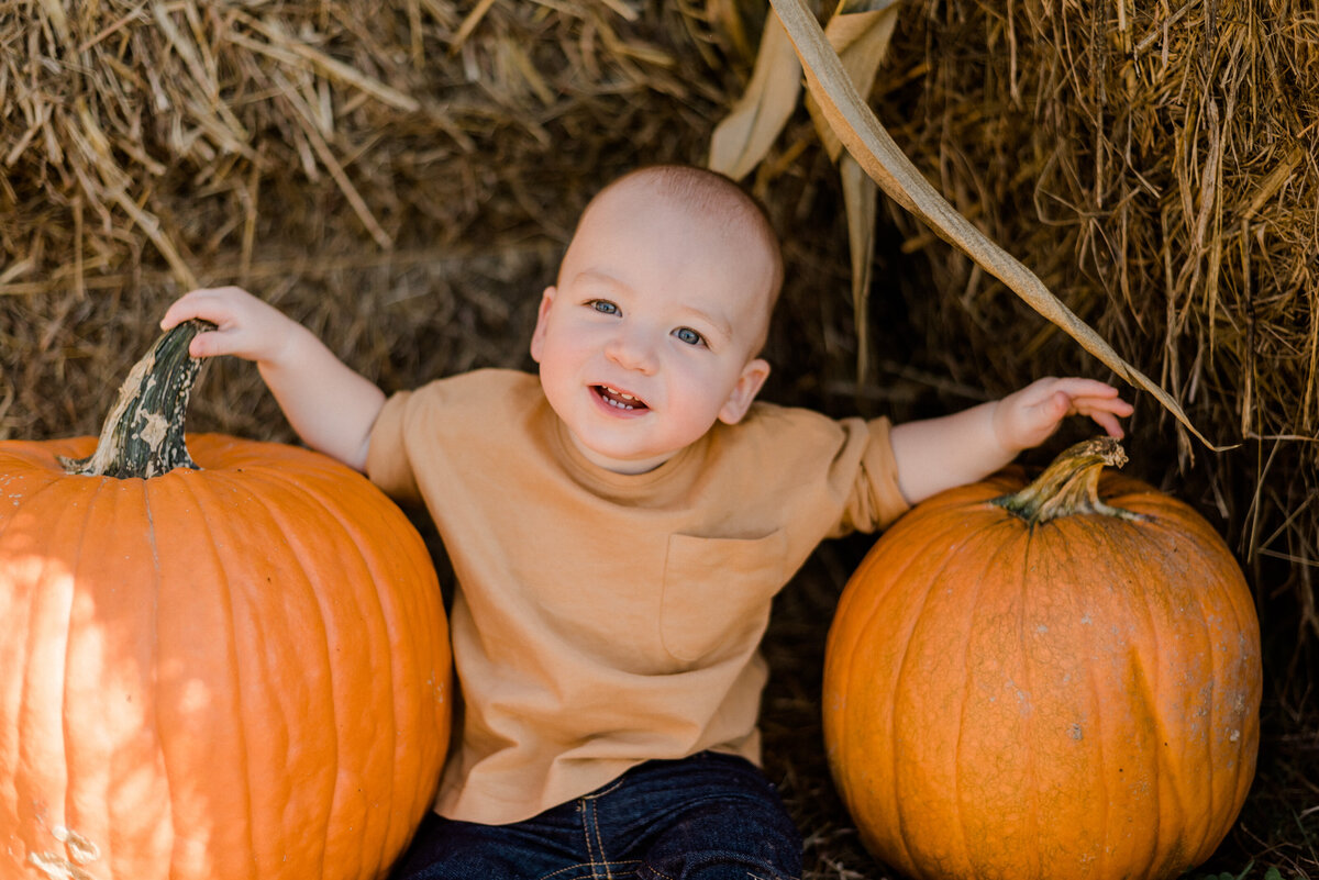 newborn fall portrait with pumpkins
