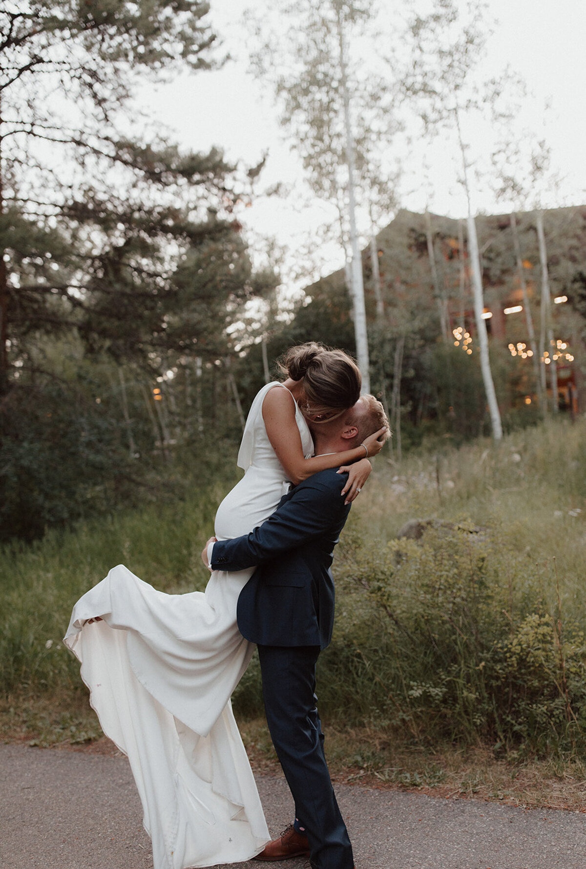 Alana and Ryan walking through the field of grass and flowers