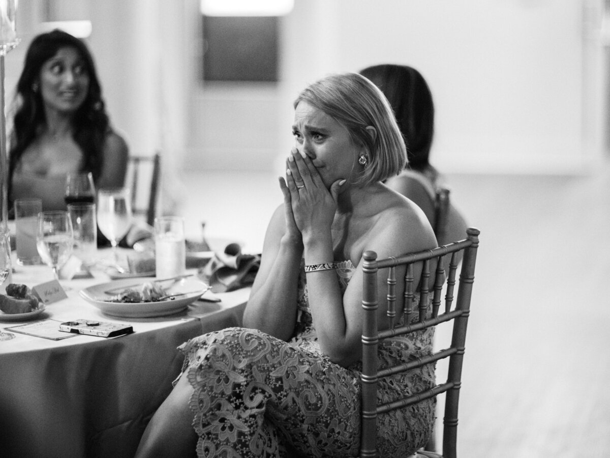 A deeply emotional moment captured as a woman expresses her feelings during a wedding, reflecting the essence of vulnerability, connection, and shared human experiences.