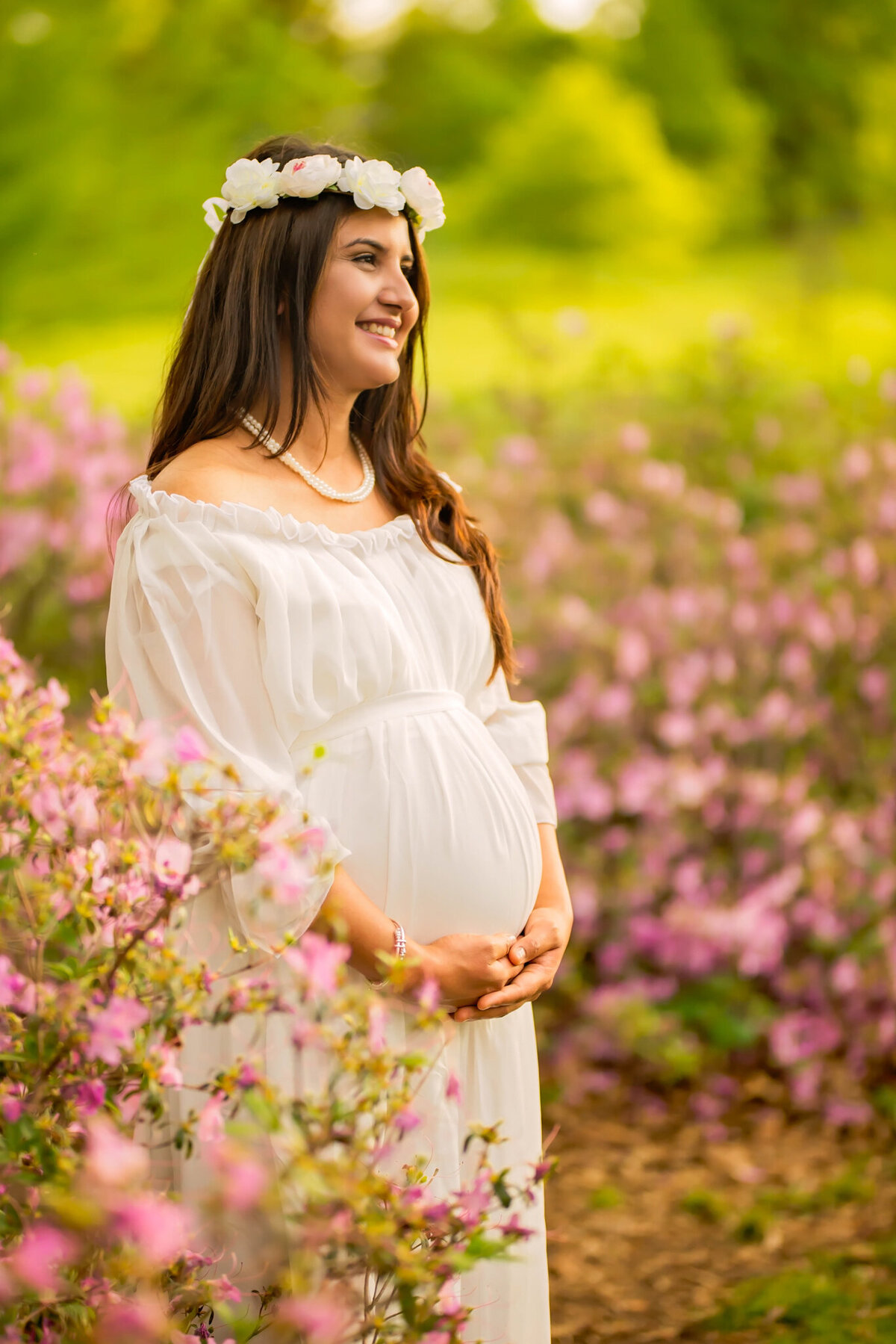 Beautiful outdoor maternity session surrounded by springtime blossoms in Olathe, Kansas. A charming choice for maternity photography in the Kansas City metro area.