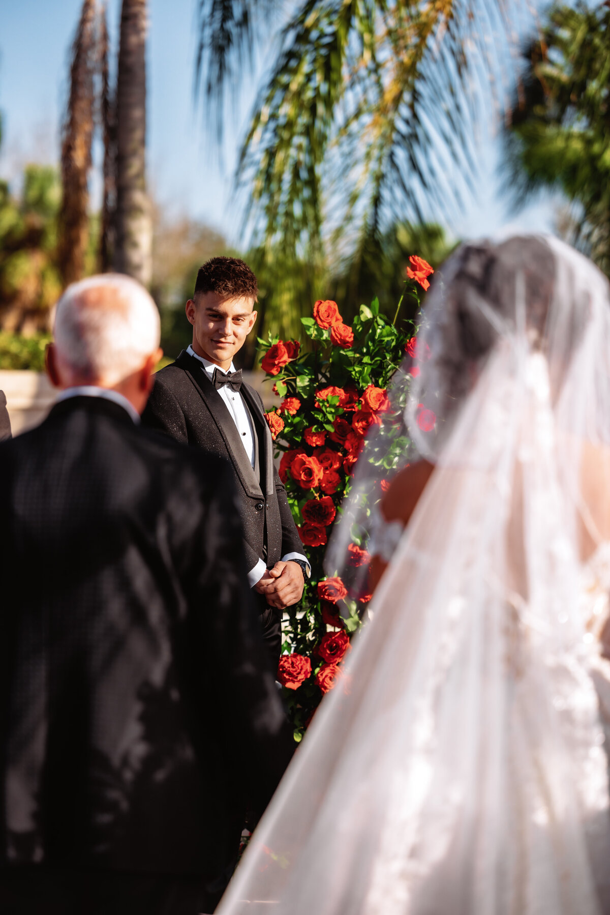 Shannon Lee, from Love Like Wild Photography, captures a groom smiling as he sees his bride walking down the aisle.