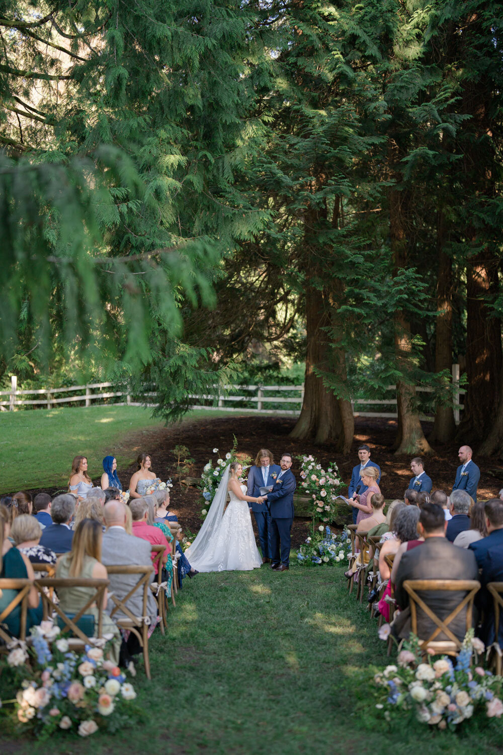 Outdoor wedding ceremony under lush trees