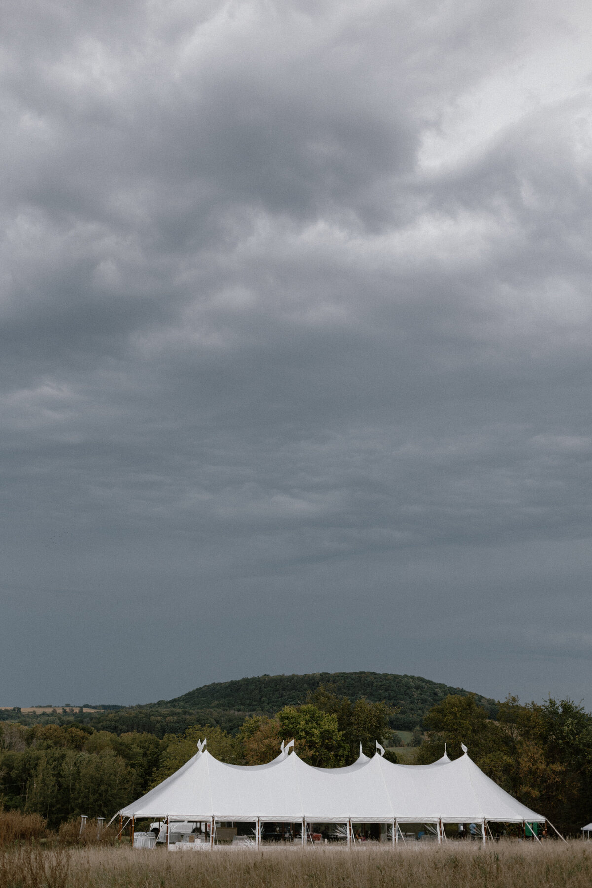 Outdoor Wisconsin wedding featuring a sailcloth tent from Event Eseentials