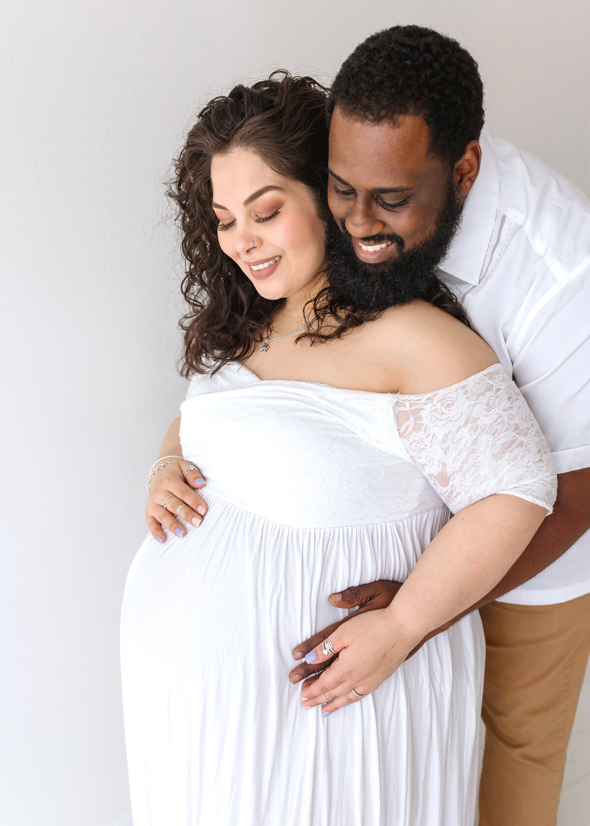 parents with hands on belly