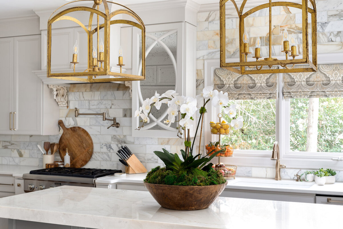 Luxurious neutral kitchen design with custom window treatments.