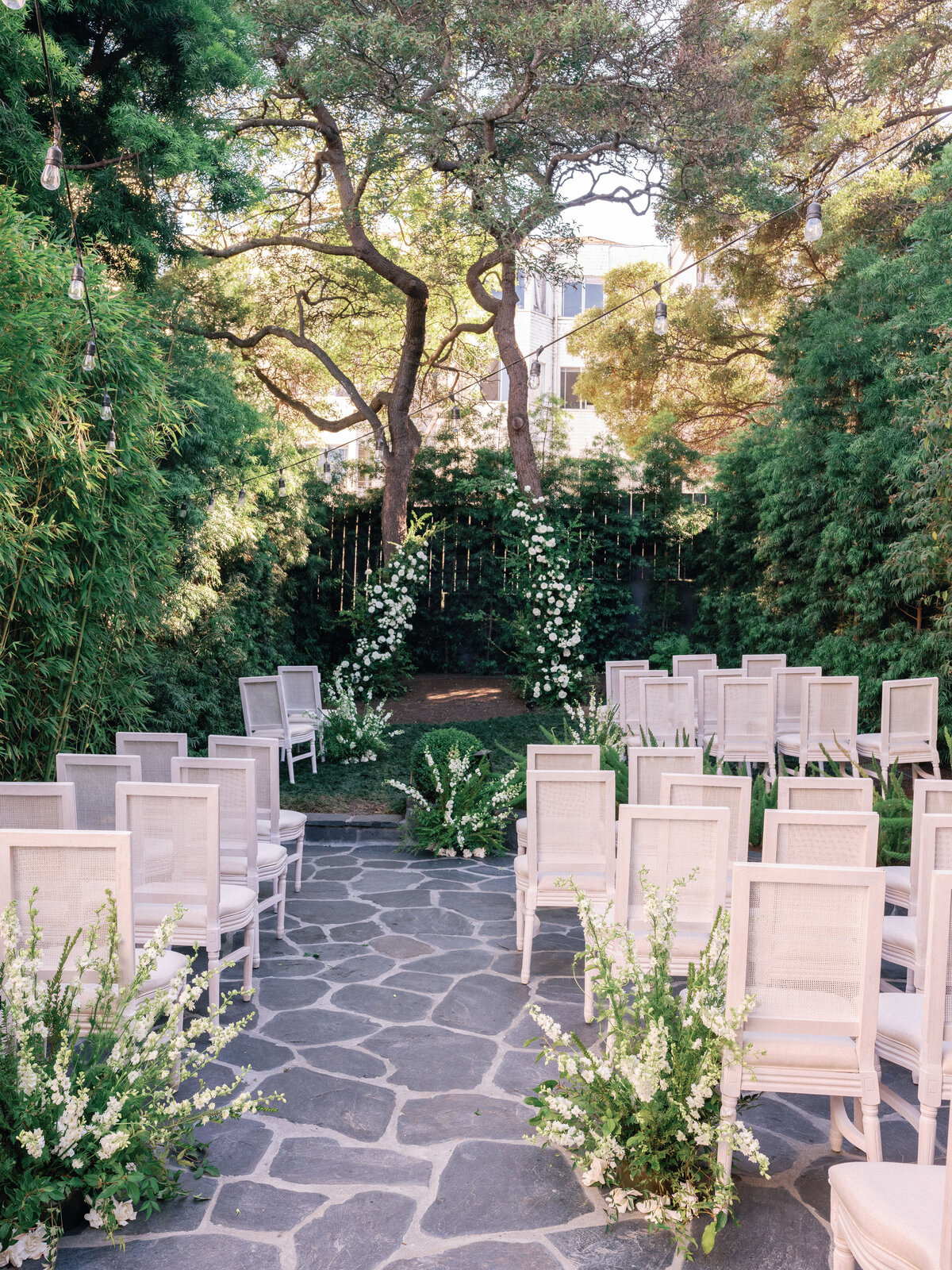 minimal and classic intimate wedding ceremony design using hensley event rentals for chairs and max gill design for flowers and altar.