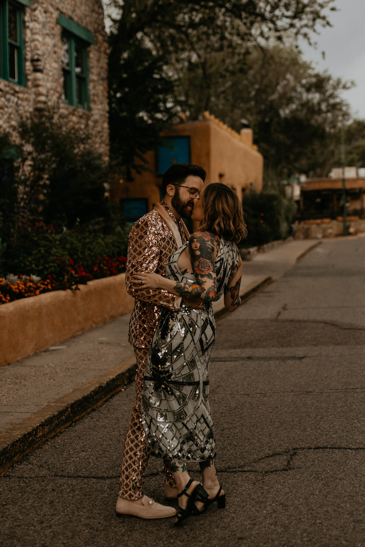 bride adn groom wearing colorful sequins walking in the street in Santa Fe