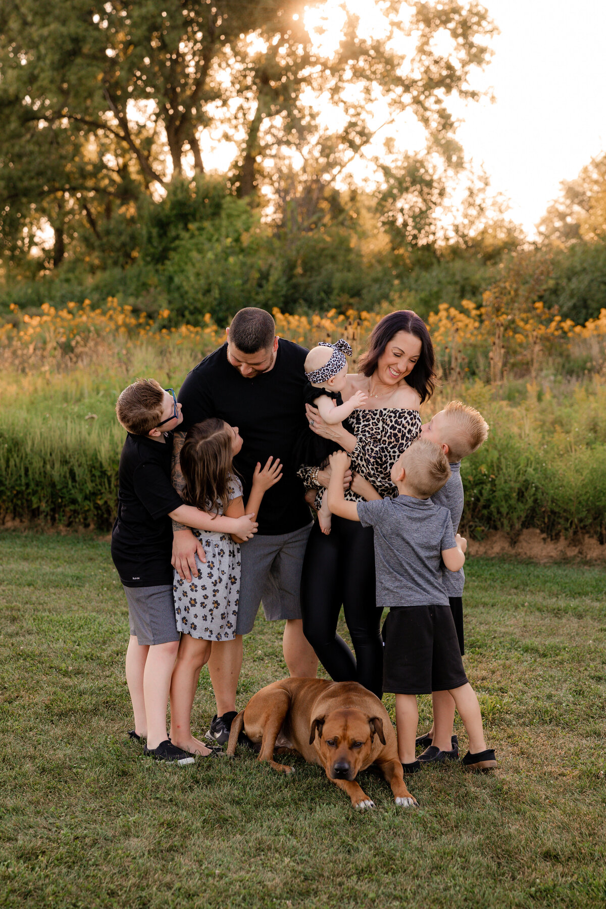 A group hug is shared beween a new blended family in Joliet at sunset.