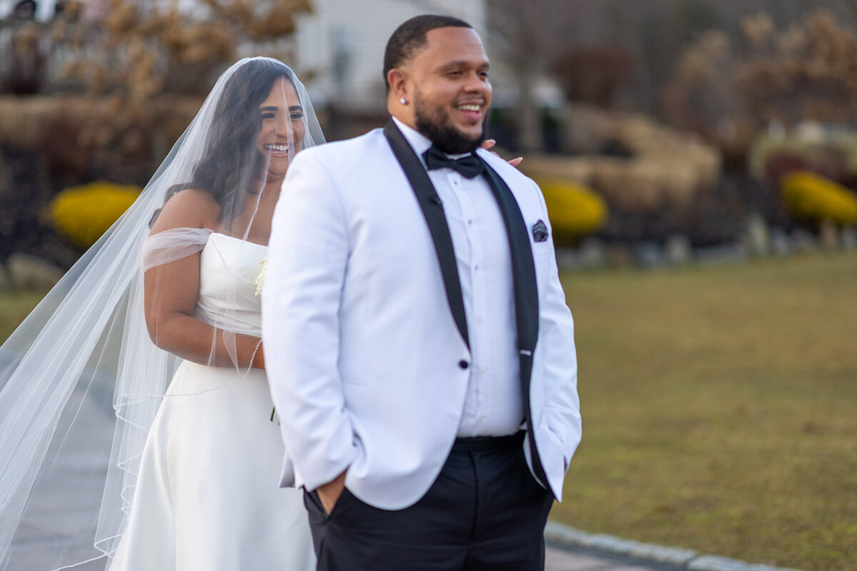Bride walking up behind groom for first look
