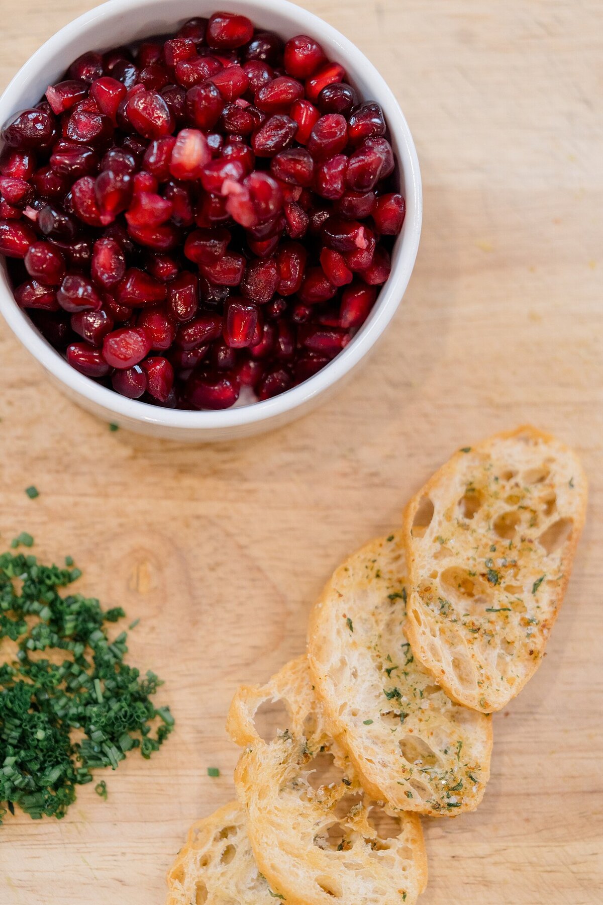 food photography with a bowl of seeds next to other ingrediant on a wood cutting board  photographed by brand photographer