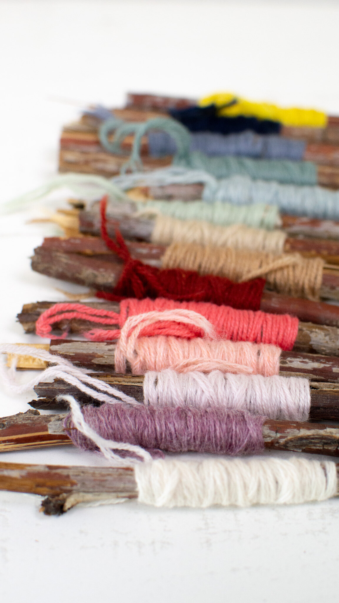 Coastal Cashmere Yarn wrapped on twigs