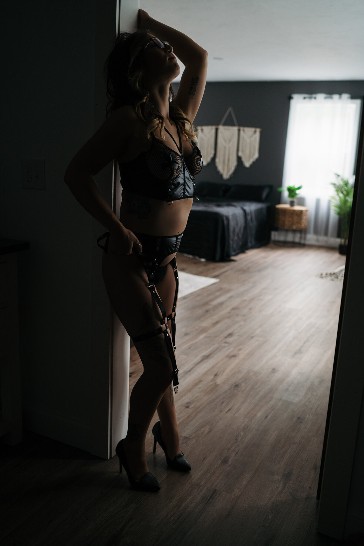 Woman wearing black lingerie posing in door frame for Worcester Boudoir Photographer Kerry Callahan Boudoir