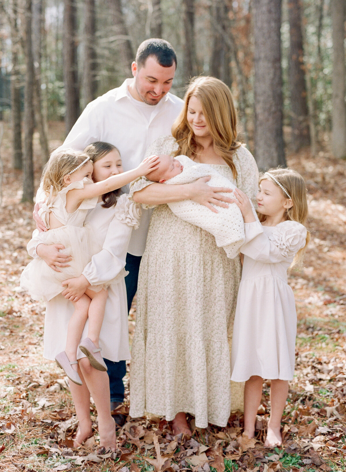 Family of 6 poses outside for a newborn photo at their Wake Forest NC home. Image by Raleigh newborn photographer A.J. Dunlap Photography.