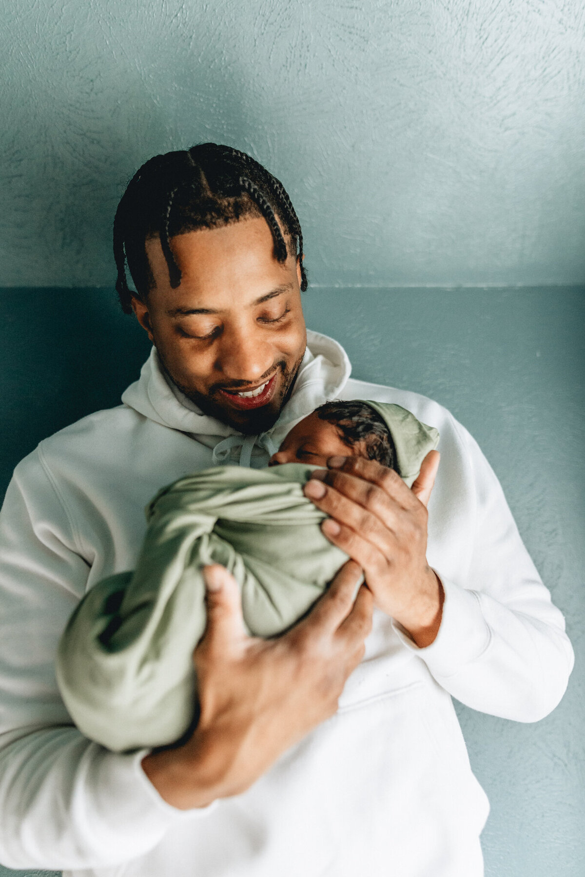 Family photography of dad holding newborn baby