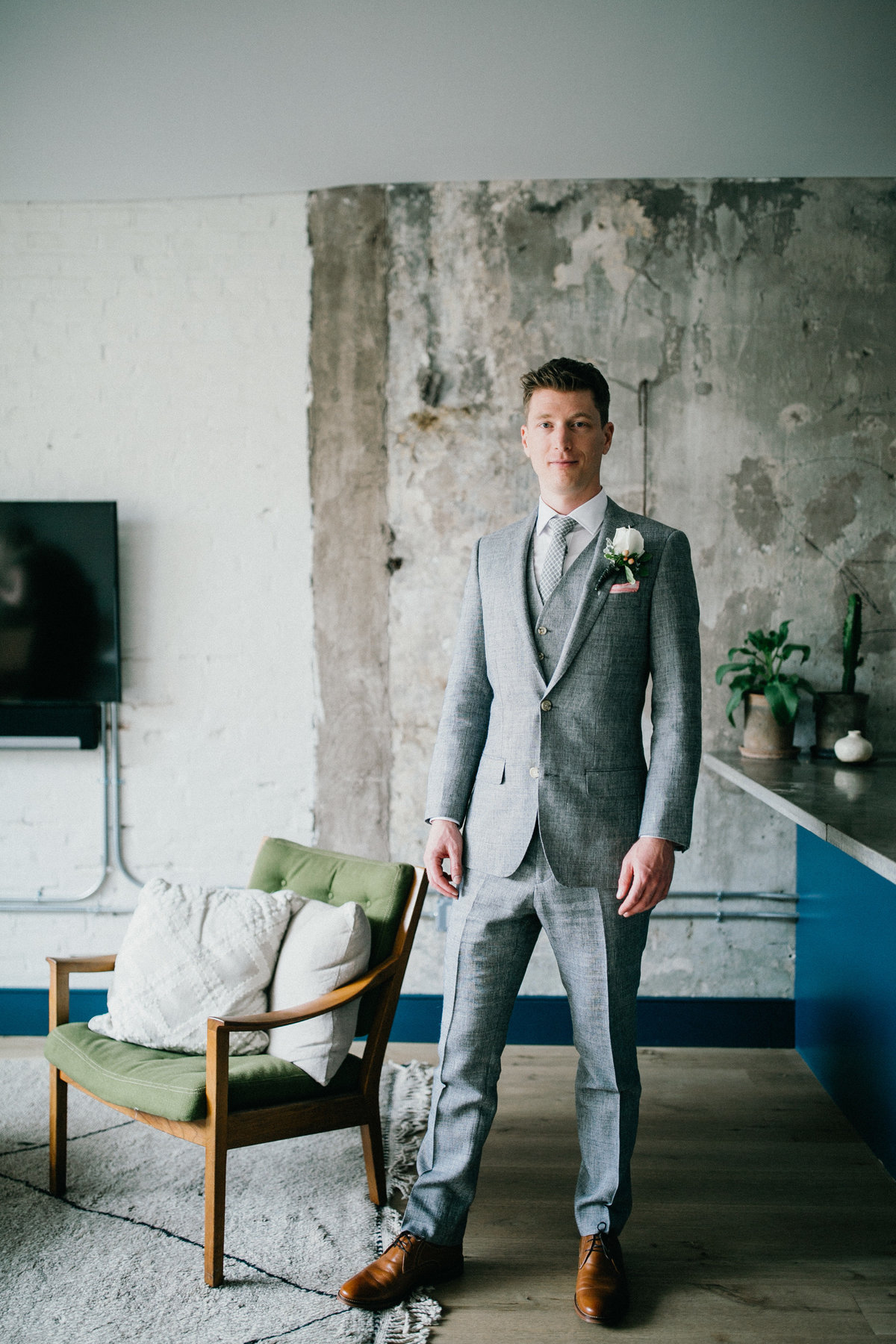 Handsome groom getting ready at Lokal Hotel in Old City before the wedding.