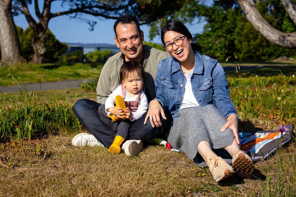Candid moment of parents and toddler bonding by the San Francisco Bay – natural light family photography by Ellobelle Photography, San Francisco Peninsula Bay Trail Burlingame
