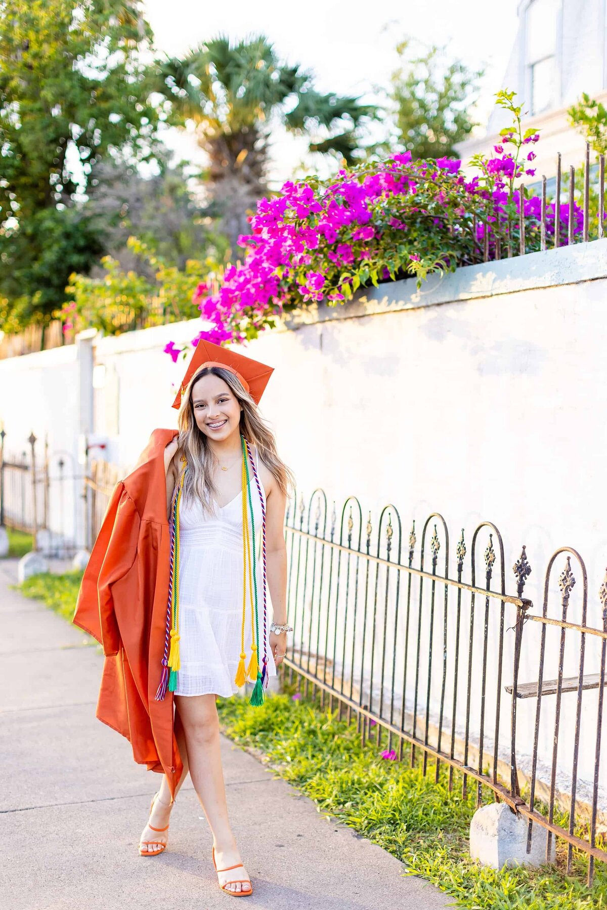 Senior girl holding graduation gown