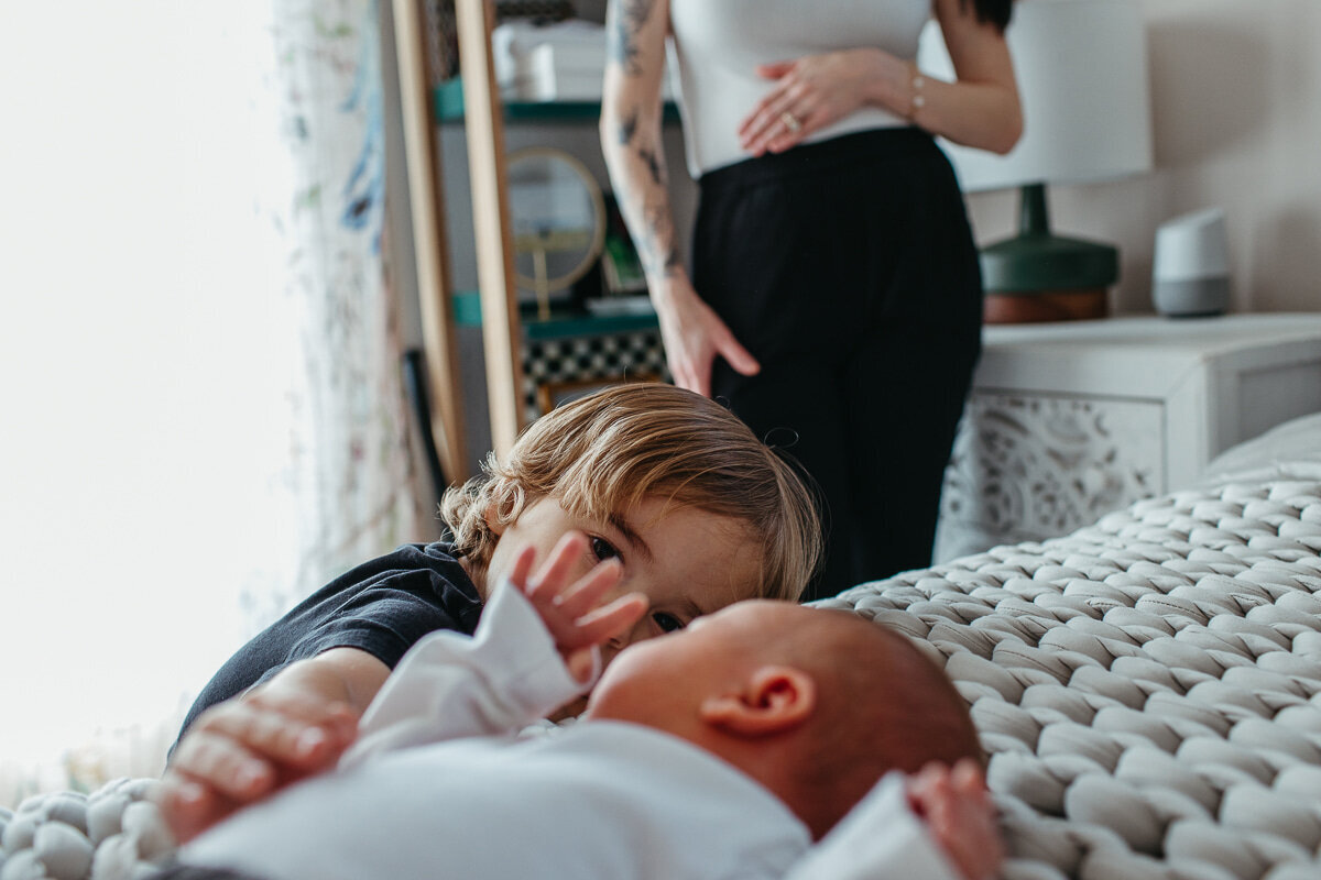 brother_touching_baby