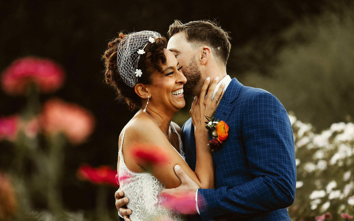 Bride and groom share a joyful embrace during their wedding day, captured in a candid and storytelling documentary style.