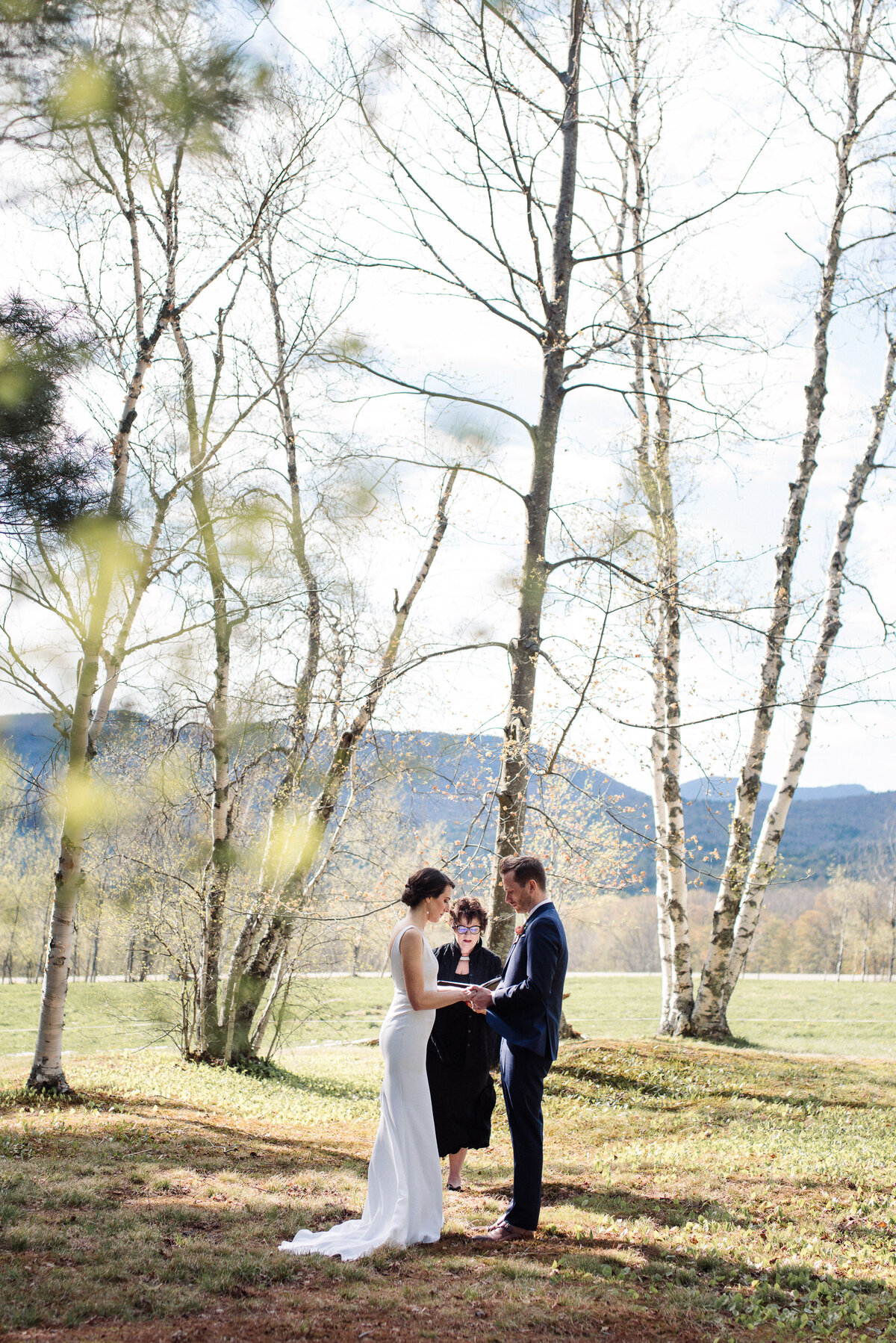 Couples elopes in birch grove in Stowe, VT with green mountains in the background. lindsey leichthammer events.