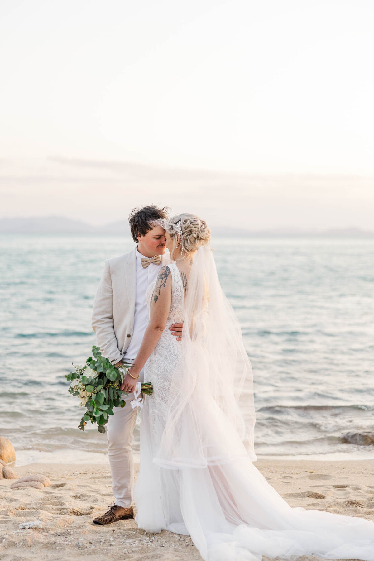 wedding portrait of bride and groom on whitsunday beach by mackay wedding photographer alyce holzy
