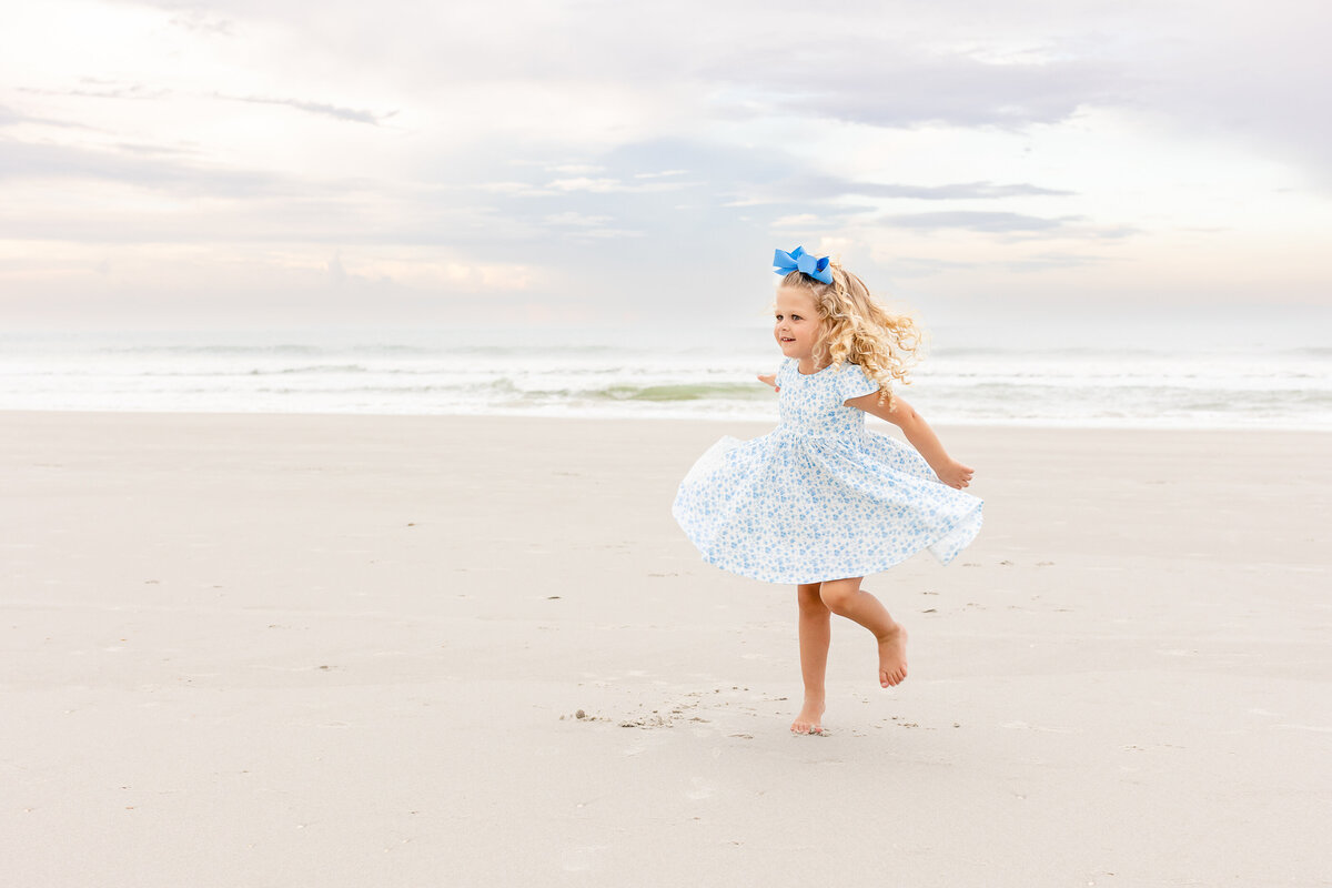 birthday girl poses on the beach during her session in Atlantic Beach