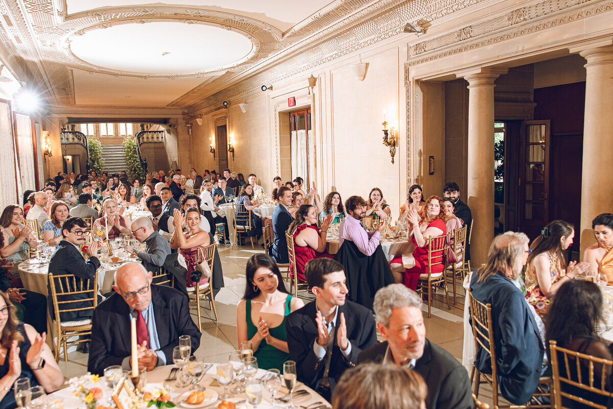 Guests toast a couple during speeches at Armour House in Lake Forest.