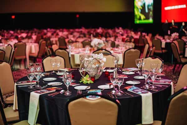 seattle university annual dinner gala with black linens and white orchid centerpiece