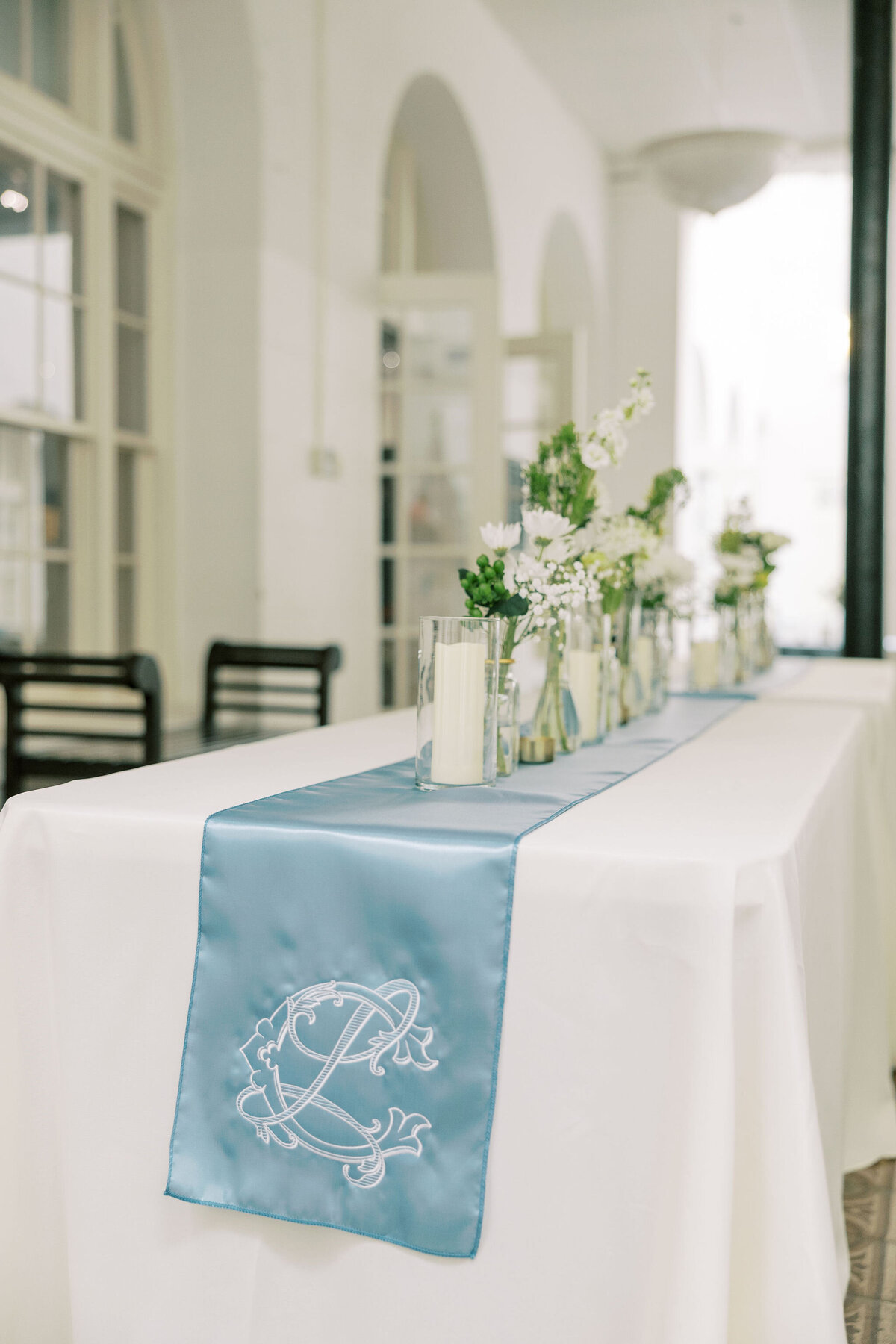 a table decorated with blue and white items for a wedding reception