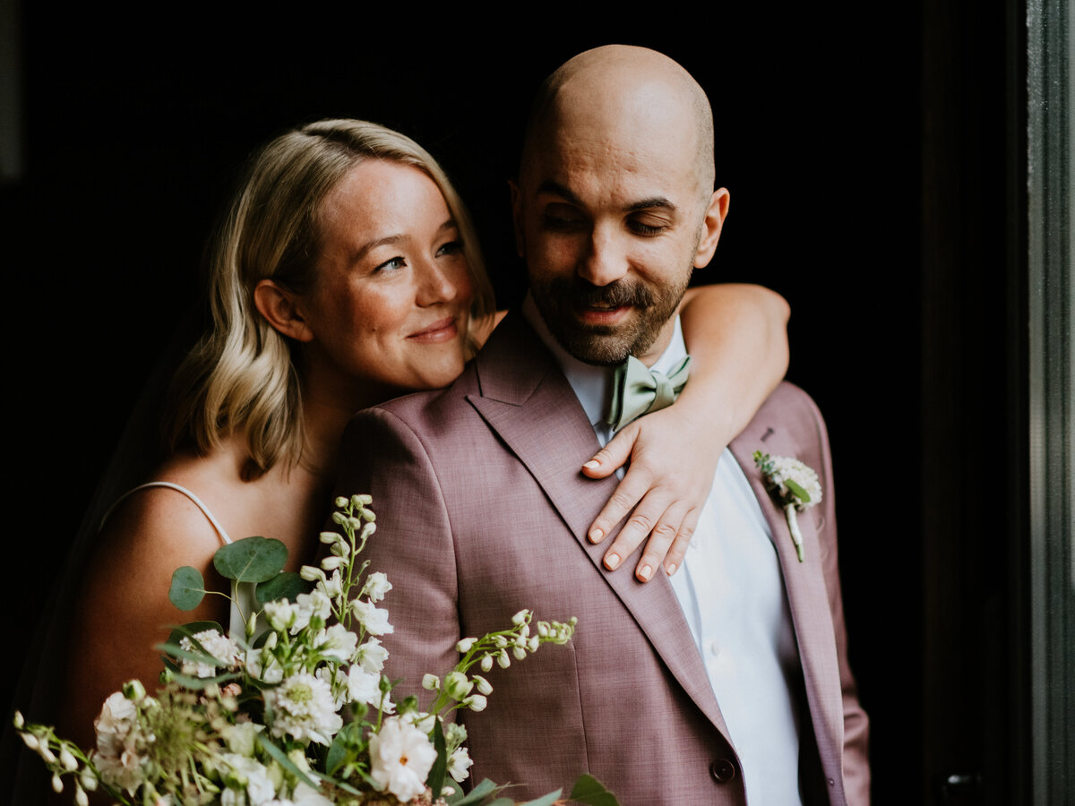 bride with arm over grooms shoulder