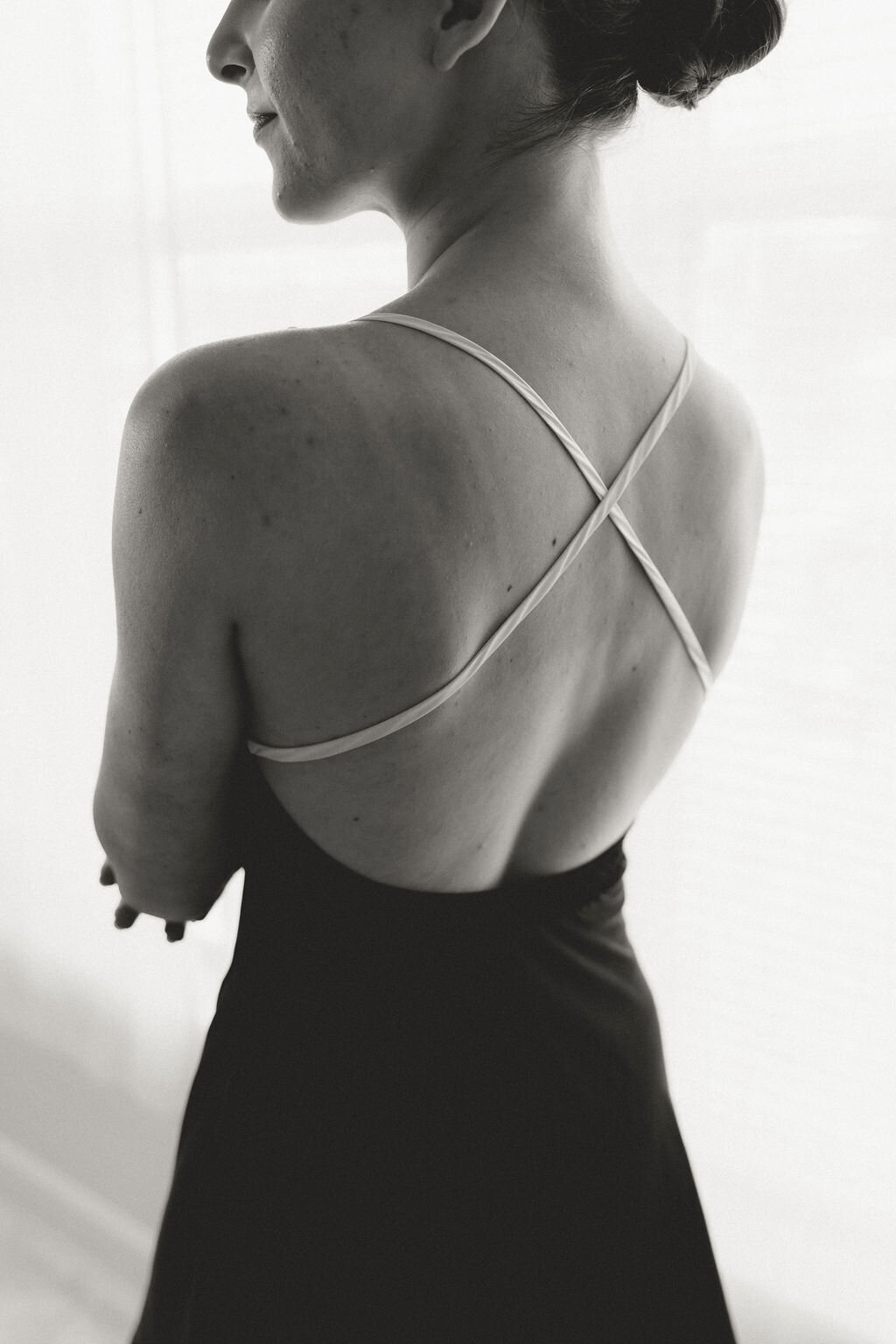 Bride getting ready in elegant satin slip dress with subtle shine
