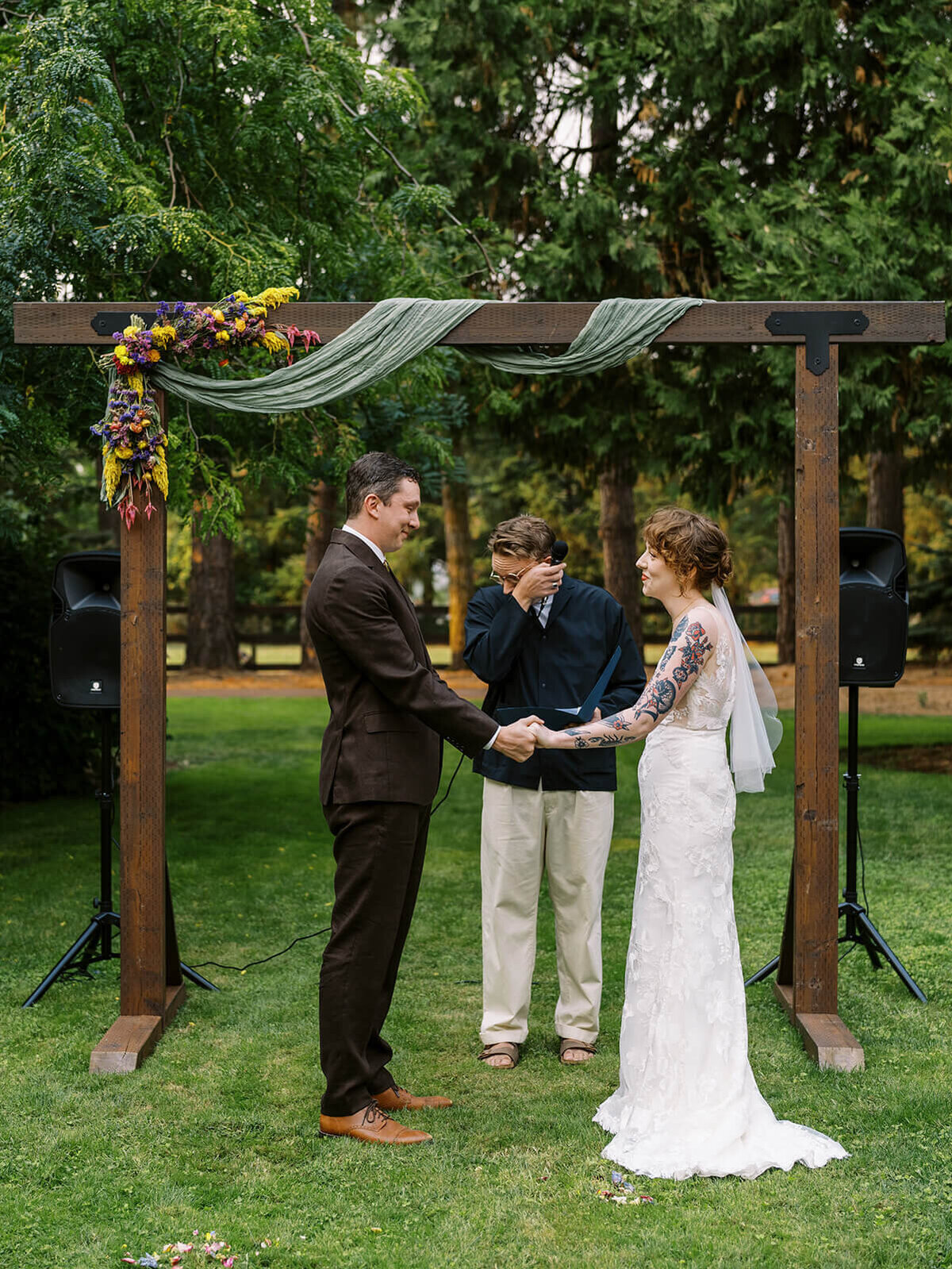 Bride and groom at the altar during their backyard wedding ceremony. 