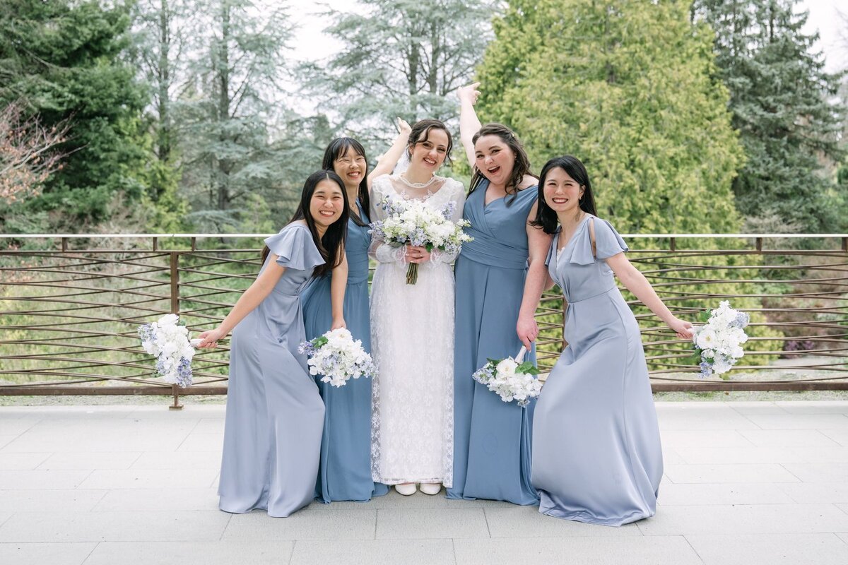 bridal party in blue dresses with bride at kubota garden