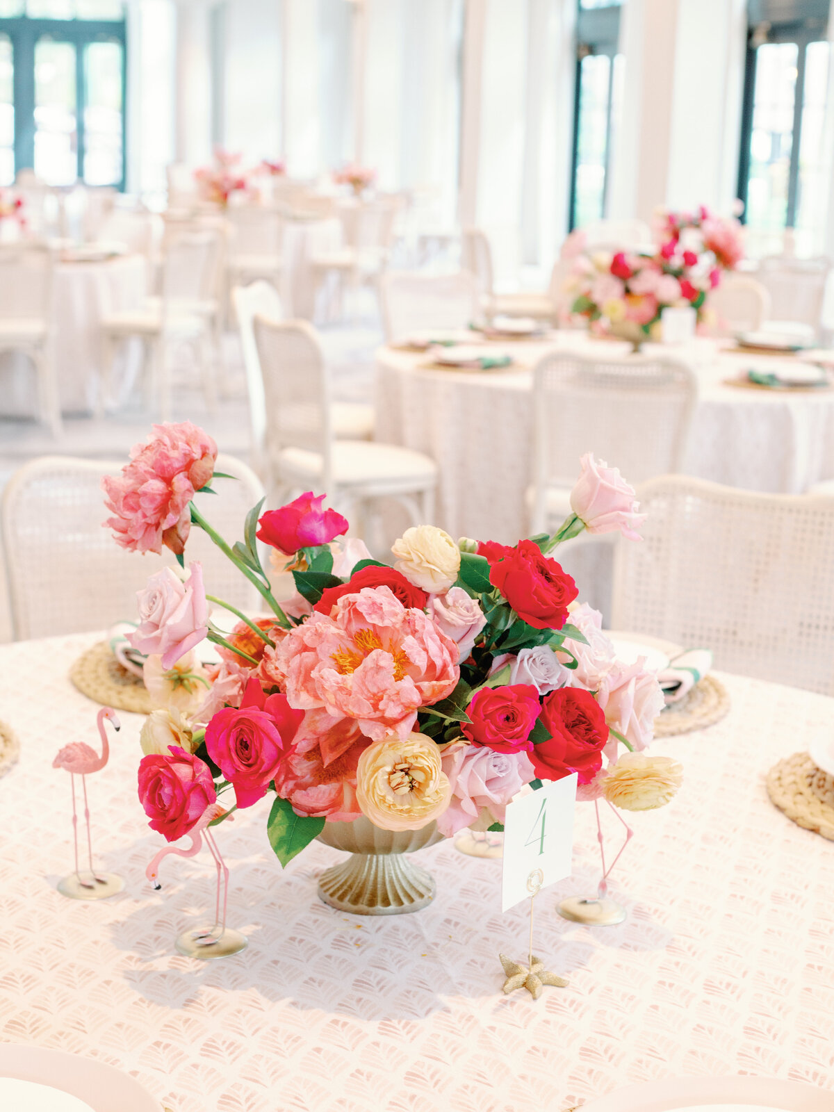 A luxurious wedding centerpiece featuring lush roses and peonies in a timeless and romantic arrangement. The rich textures and soft floral tones create an elegant focal point, perfect for upscale wedding receptions and sophisticated event décor.