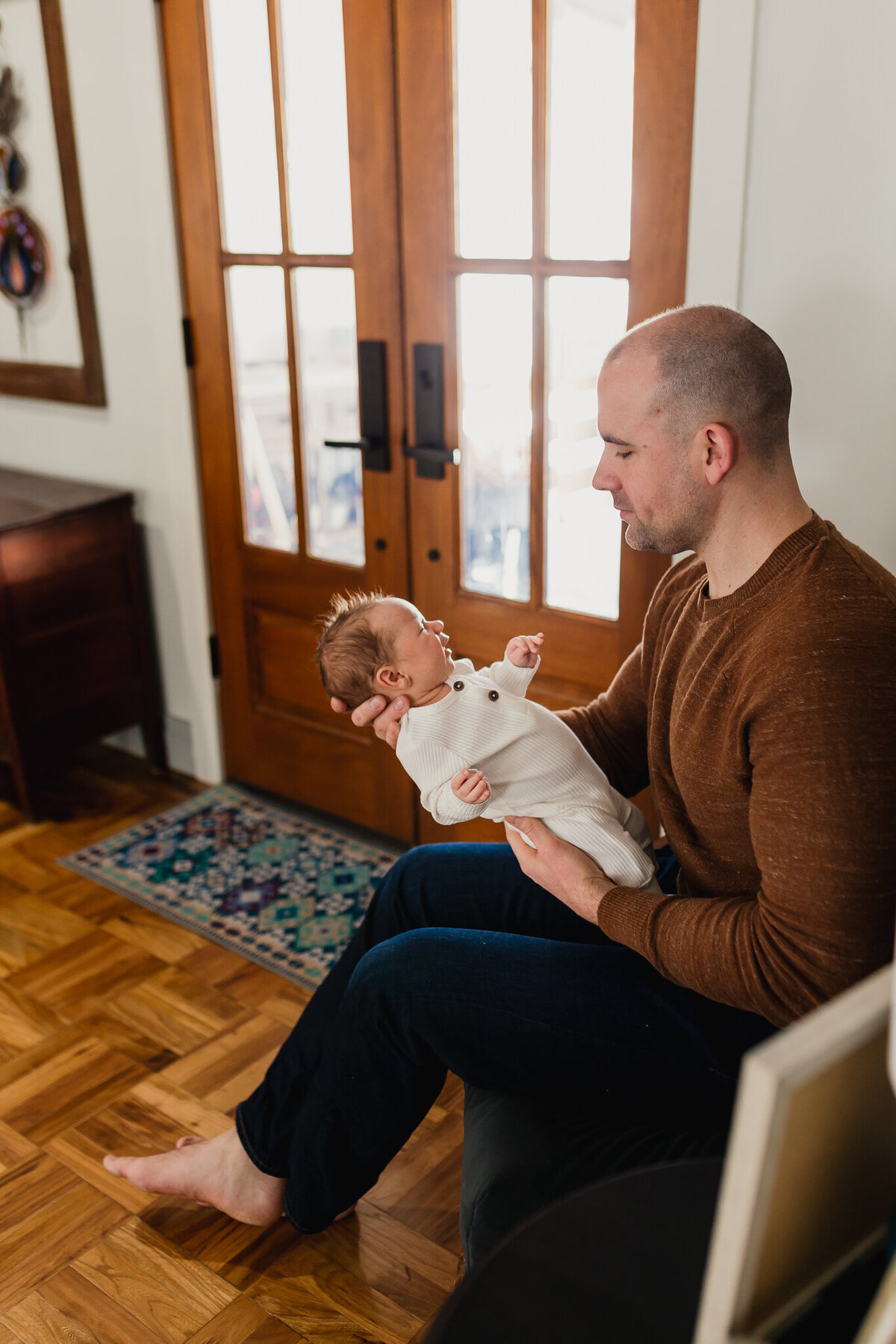Family Photoshoot Session with dad holding newborn baby.