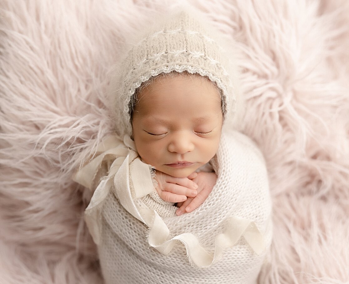 baby girl on pink fluff for newborn photography in portland oregon