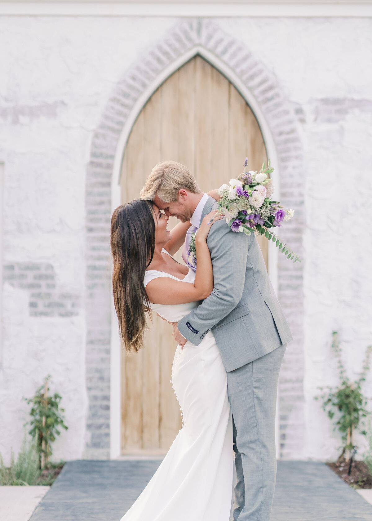 Couple embraces outside white wedding chapel near Chattanooga, TN