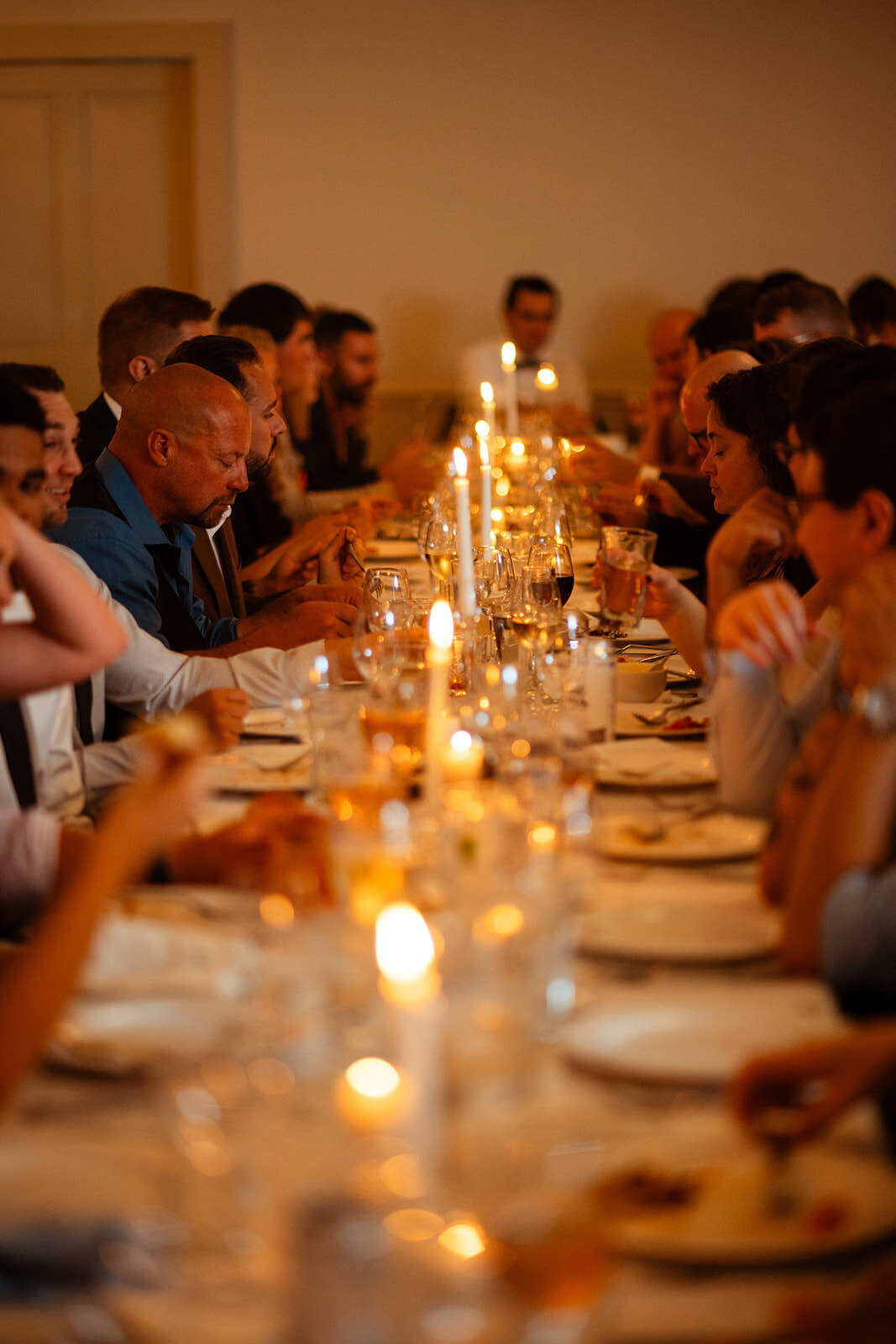 Candlelit wedding table with guests