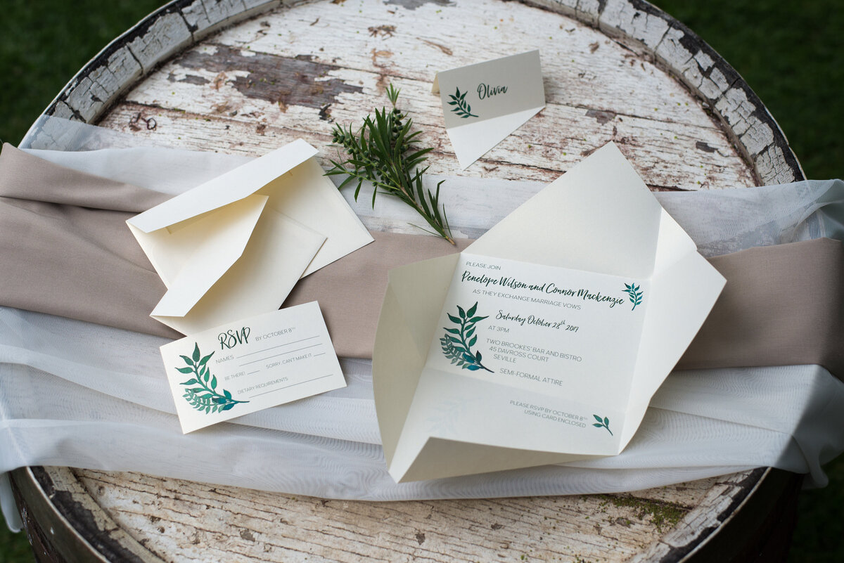 Origami wedding invitations with green leaf design and matching RSVP card and place card.
