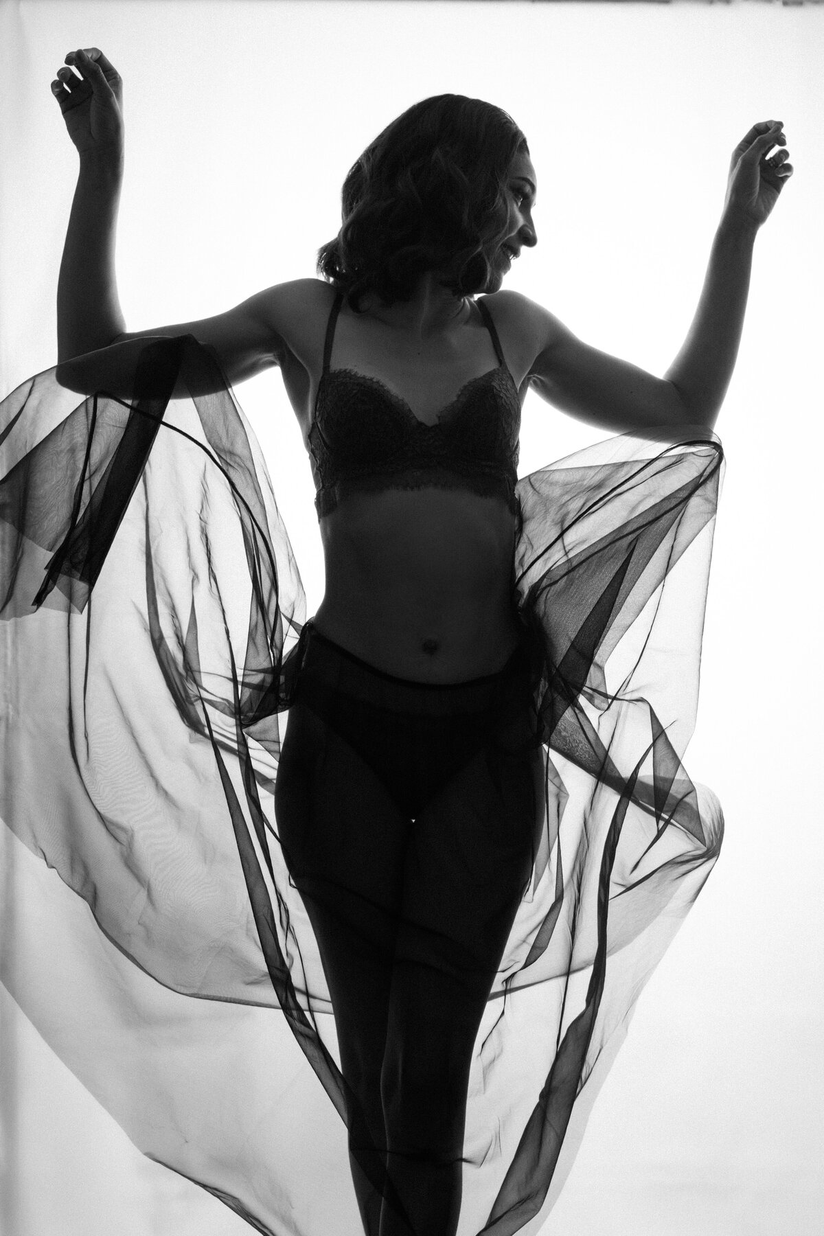 black and white photo of a woman in a sheer skirt