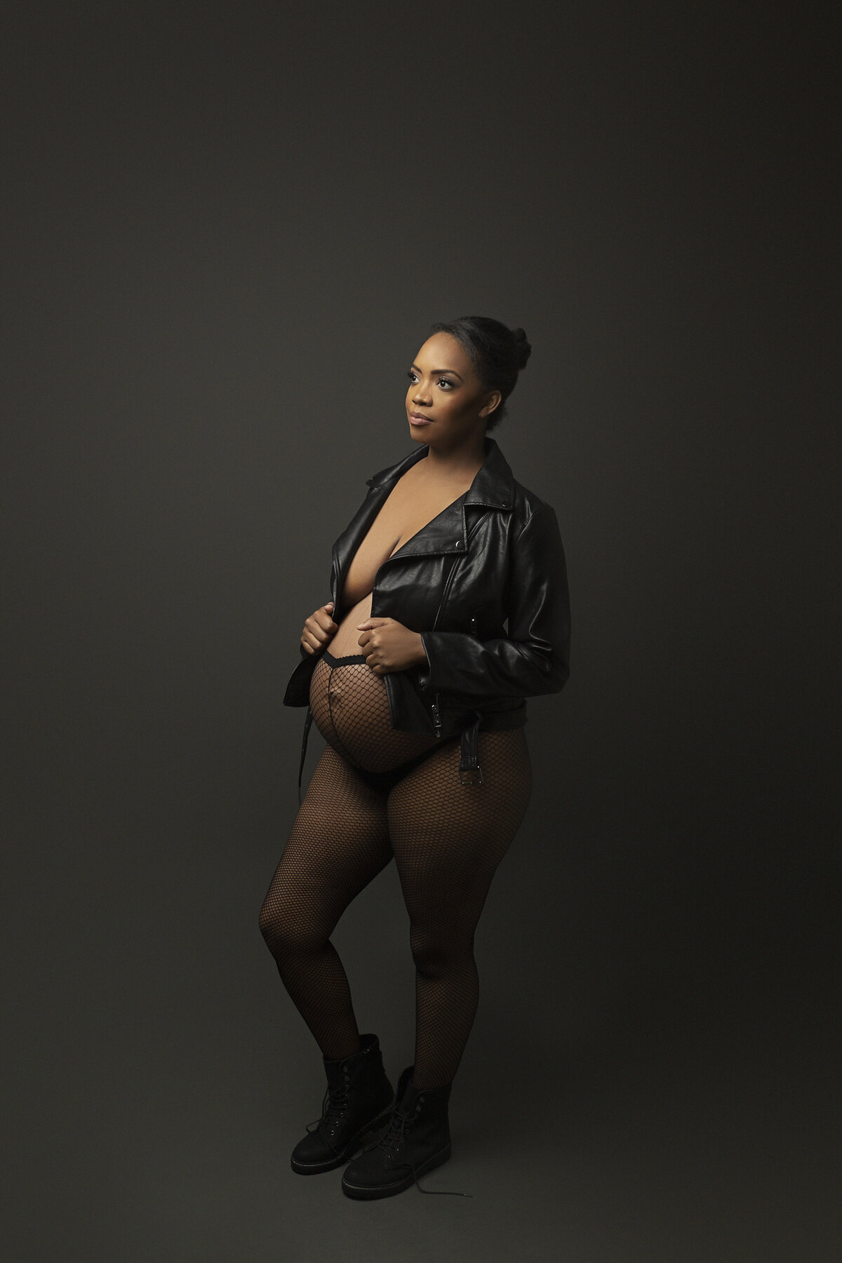 expectant mother in fishnet stockings and black leather jacket for maternity session