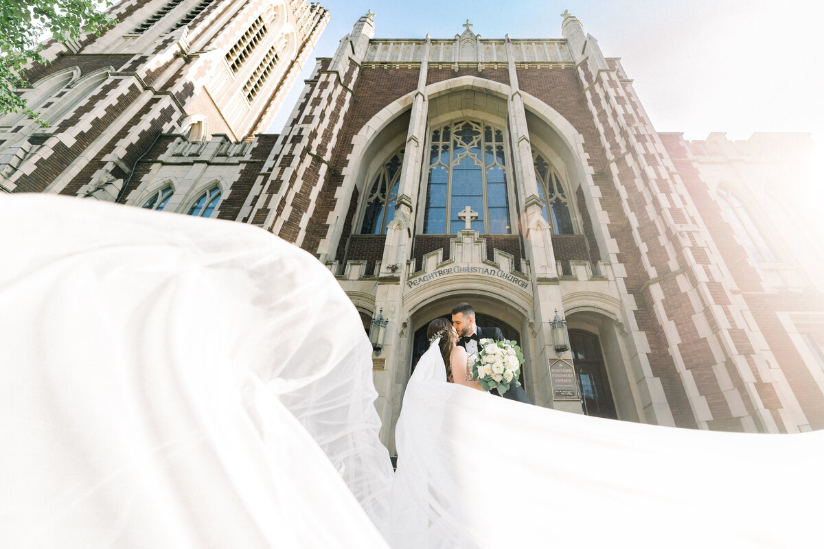 peachtree-christian-church-wedding-veil-flying-wind-bride-and-groom-portraits