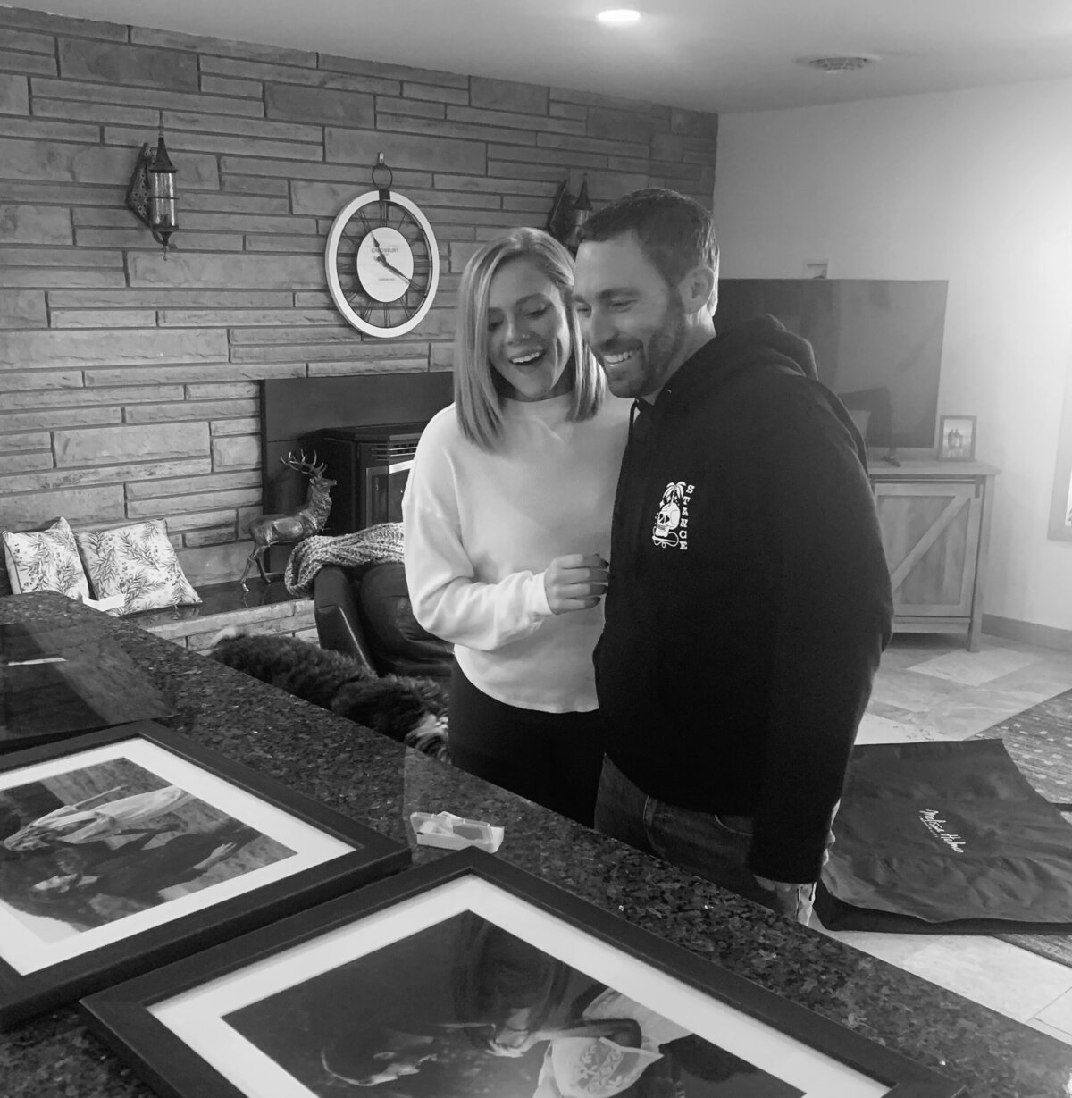 Couple looks at their framed pictures after family photoshoot in Latrobe