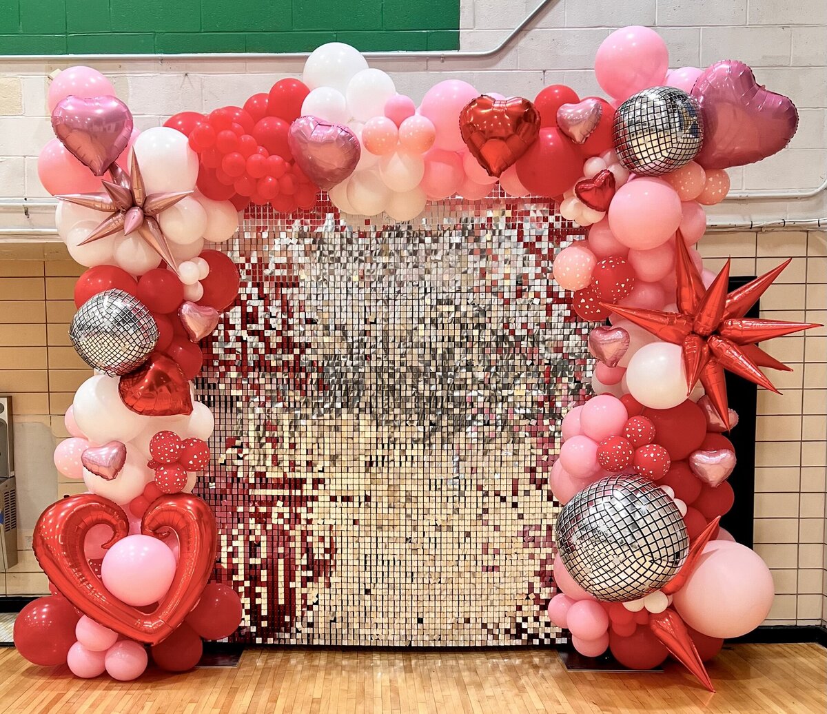 silver shimmer wall with pink balloons
