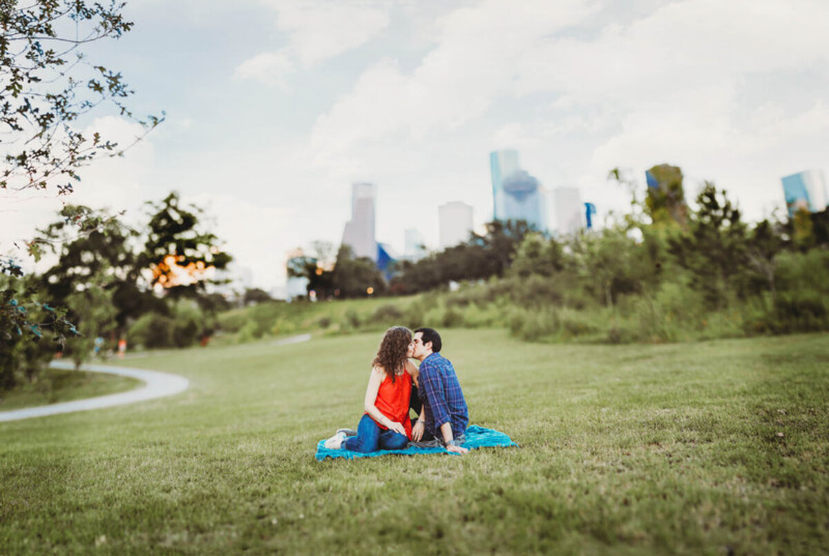 Couple Sitting in Park with Skyline