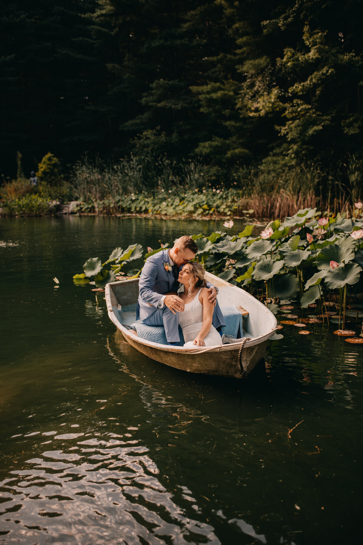 Couple sits in boat at Chatfield Hollow Inn on Wedding day with Connecticut Wedding Photographer