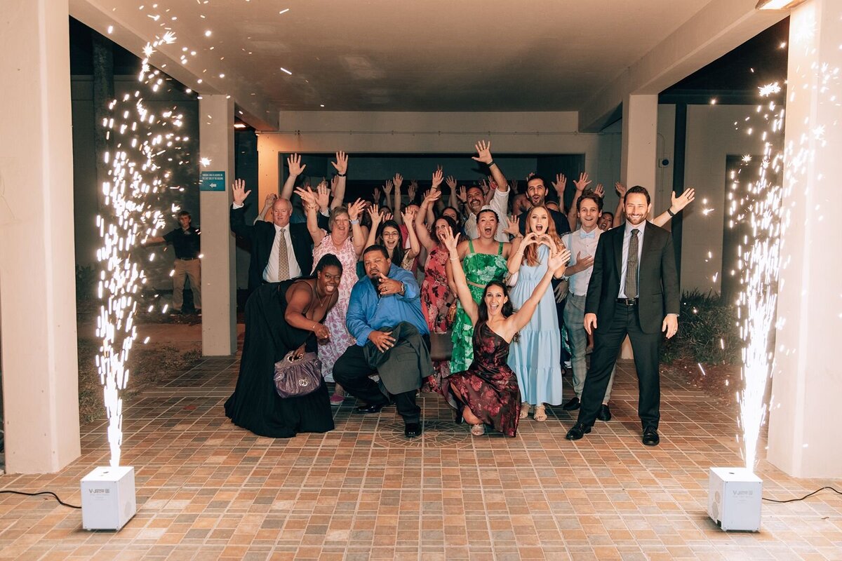 all of the wedding guests waving goodbye during the grand exit