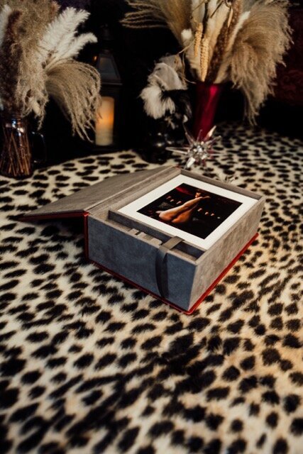 Boudoir photography keepsake images in box on leopard rug in Lubbock, Texas photographer in Amarillo TX