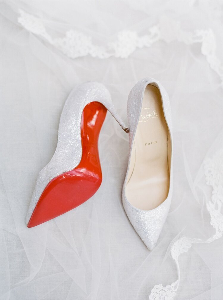 Bride's white shoes with red soles