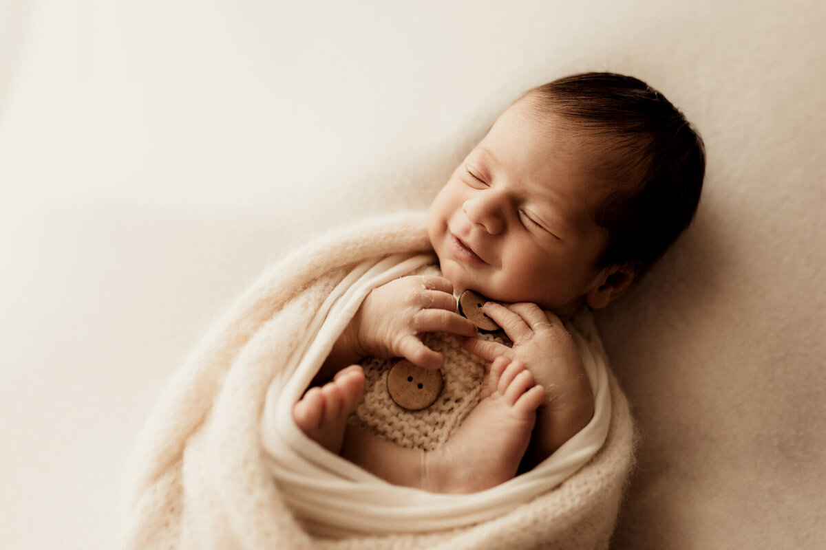 Smiling newborn baby boy.